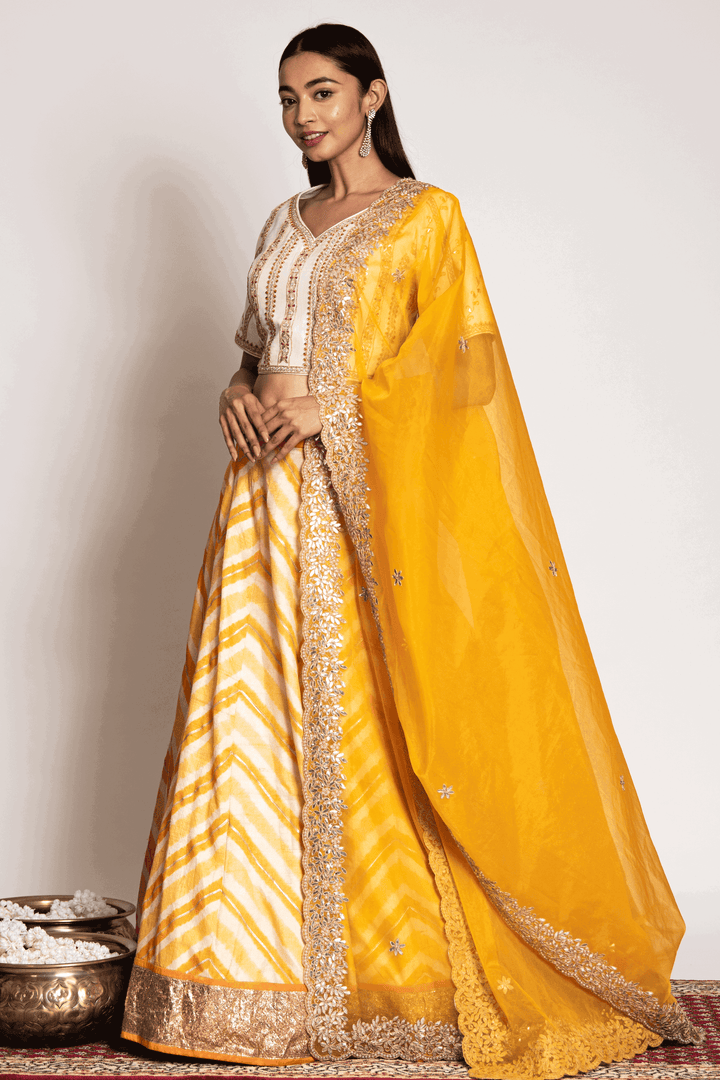 Off White Gota Blouse Paired With Yellow Leheriya Skirt And Organza Dupatta - Bandhani