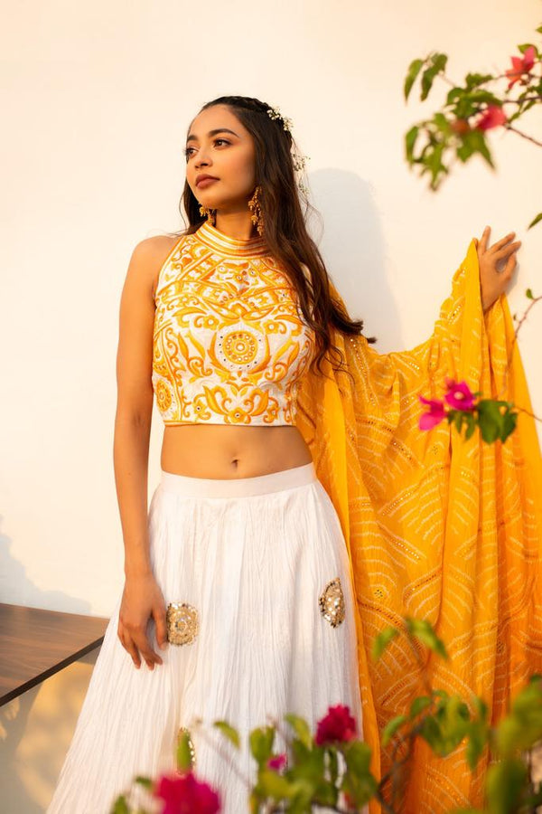 Yellow And Ivory Lehenga Set With Hand Embroidered Mirror Work Embellished Halter Neck Blouse And Bandhani Dupatta